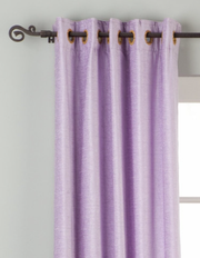 Lavender velvet grommet top curtains hung at a window