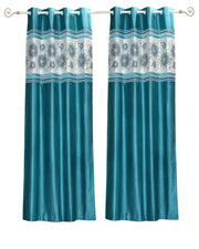 Turquoise sari grommet top curtains hung at a window