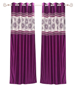 Wine sari grommet top curtains hung at a window