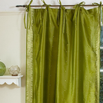 Olive green sari tie top curtains hung at a window
