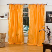 Pumpkin sari tie top curtains hung at a window