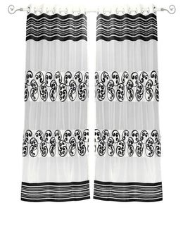 Black sheer tissue ring top curtains hung at a window