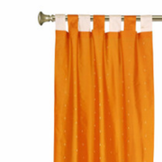 Orange sari tab top curtains hung at a window