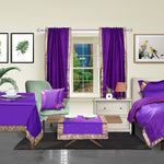 Purple sari rod pocket curtains hung at a window