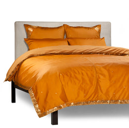 Mustard sari duvet cover set made up on a bed