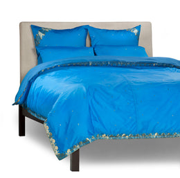 Blue sari duvet cover set made up on a bed