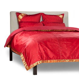 Maroon sari duvet cover set made up on a bed