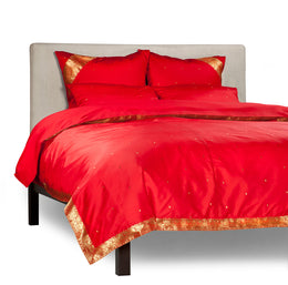 Fire brick sari duvet cover set made up on a bed