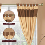 Brown raw silk tab top curtains hung at a window