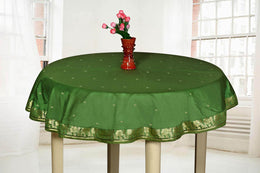 Forest green sari tablecloth laid on a dining table