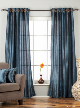 Navy blue sari grommet top curtains hung at a window