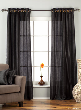 Black sari grommet top curtains hung at a window