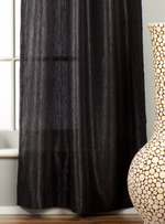 Black sari tab top curtains hung at a window
