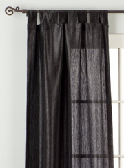 Black sari tab top curtains hung at a window