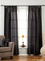 Black sari tab top curtains hung at a window