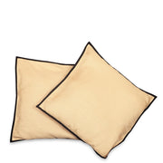 Black raw silk cushion covers arranged on a sofa
