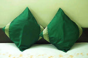 Forest green sari cushion covers arranged on a sofa