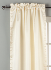 Cream sari rod pocket curtains hung at a window
