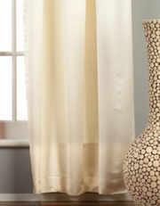 Cream sari tab top curtains hung at a window