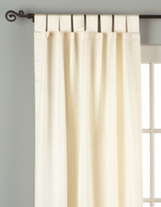 Cream sari tab top curtains hung at a window