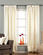 Cream sari tab top curtains hung at a window