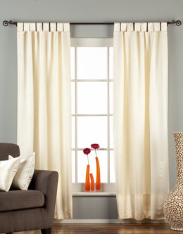 Cream sari tab top curtains hung at a window