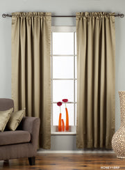 Olive green sari rod pocket curtains hung at a window