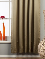Olive green sari rod pocket curtains hung at a window