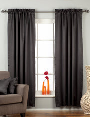 Black sari rod pocket curtains hung at a window
