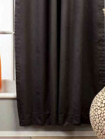 Black sari tab top curtains hung at a window
