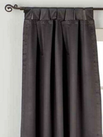 Black sari tab top curtains hung at a window