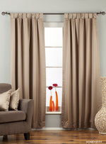 Gray sari tab top curtains hung at a window
