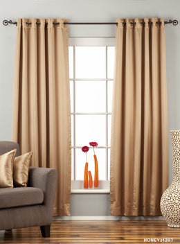 Taupe sari grommet top curtains hung at a window