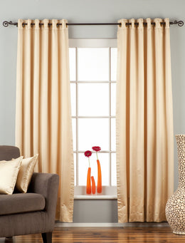 Golden sari grommet top curtains hung at a window