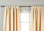Golden sari tab top curtains hung at a window