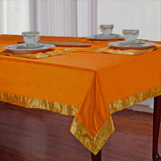 Pumpkin sari tablecloth laid on a dining table