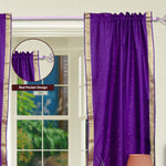 Purple sari rod pocket curtains hung at a window