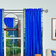 Blue sari rod pocket curtains hung at a window