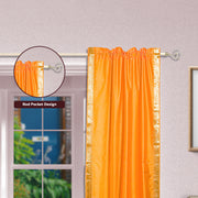 Pumpkin sari rod pocket curtains hung at a window