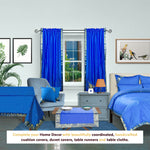 Blue sari rod pocket curtains hung at a window