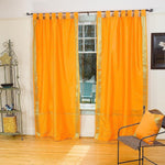 Pumpkin sari tab top curtains hung at a window