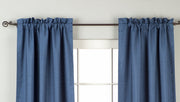 Blue raw silk rod pocket curtains hung at a window