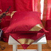 Maroon sari cushion covers arranged on a sofa