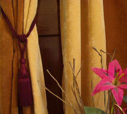 Maroon sari curtain tiebacks holding a panel open