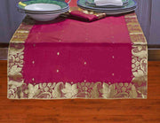 Maroon silk table runner running down a dining table