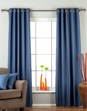 Blue raw silk ring top curtains hung at a window