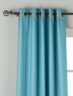 Turquoise raw silk ring top curtains hung at a window
