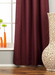 Maroon raw silk tab top curtains hung at a window
