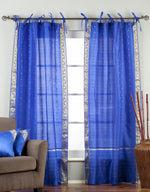 Blue sari tie top curtains hung at a window