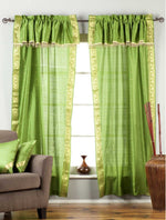 Cream sari rod pocket curtains hung at a window